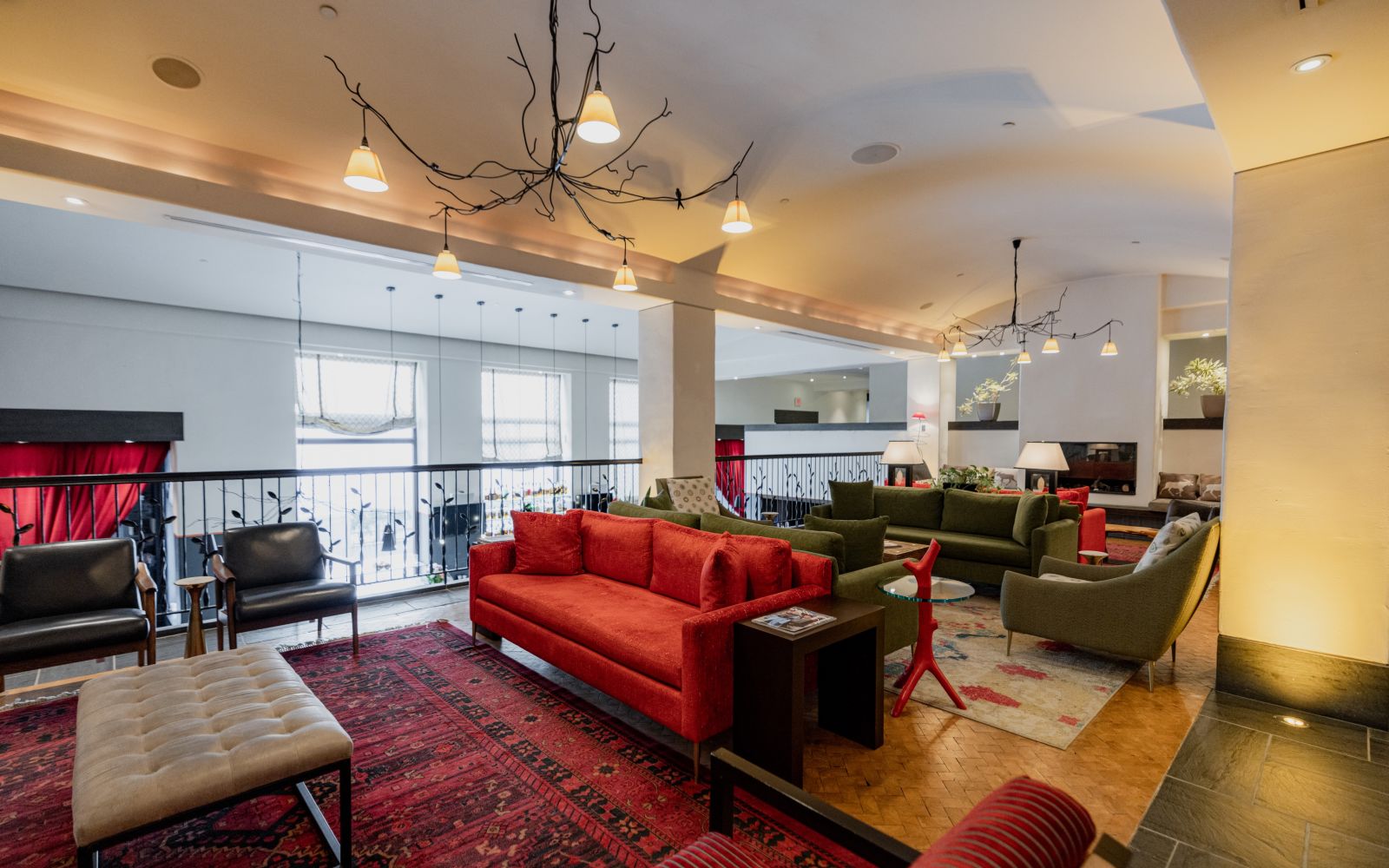A Room With Red Couches And A Table