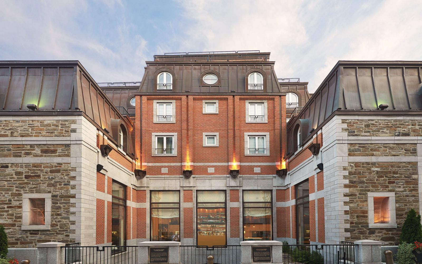 A Brick Building With A Black Fence