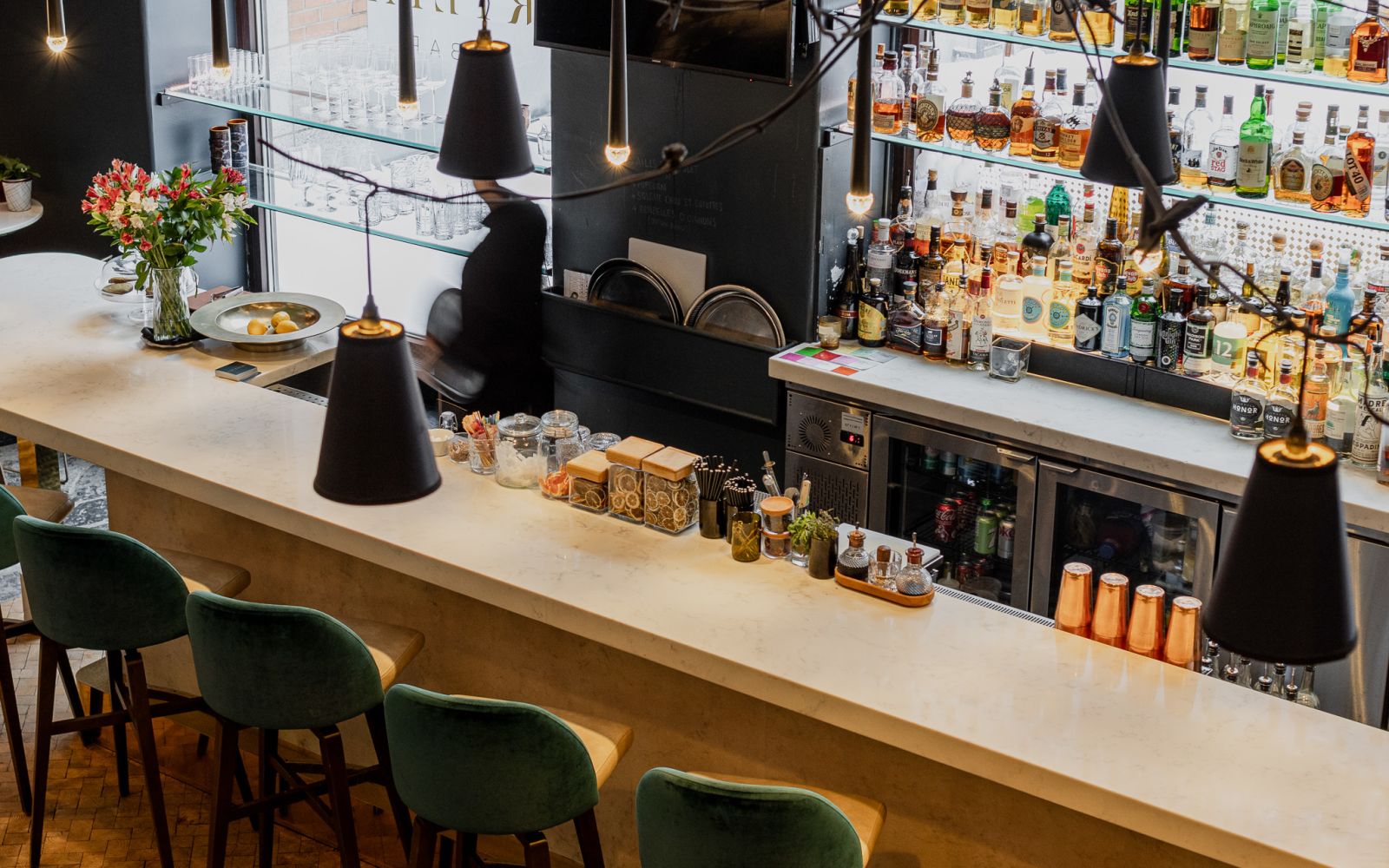 A Counter With Many Bottles Of Liquid On It